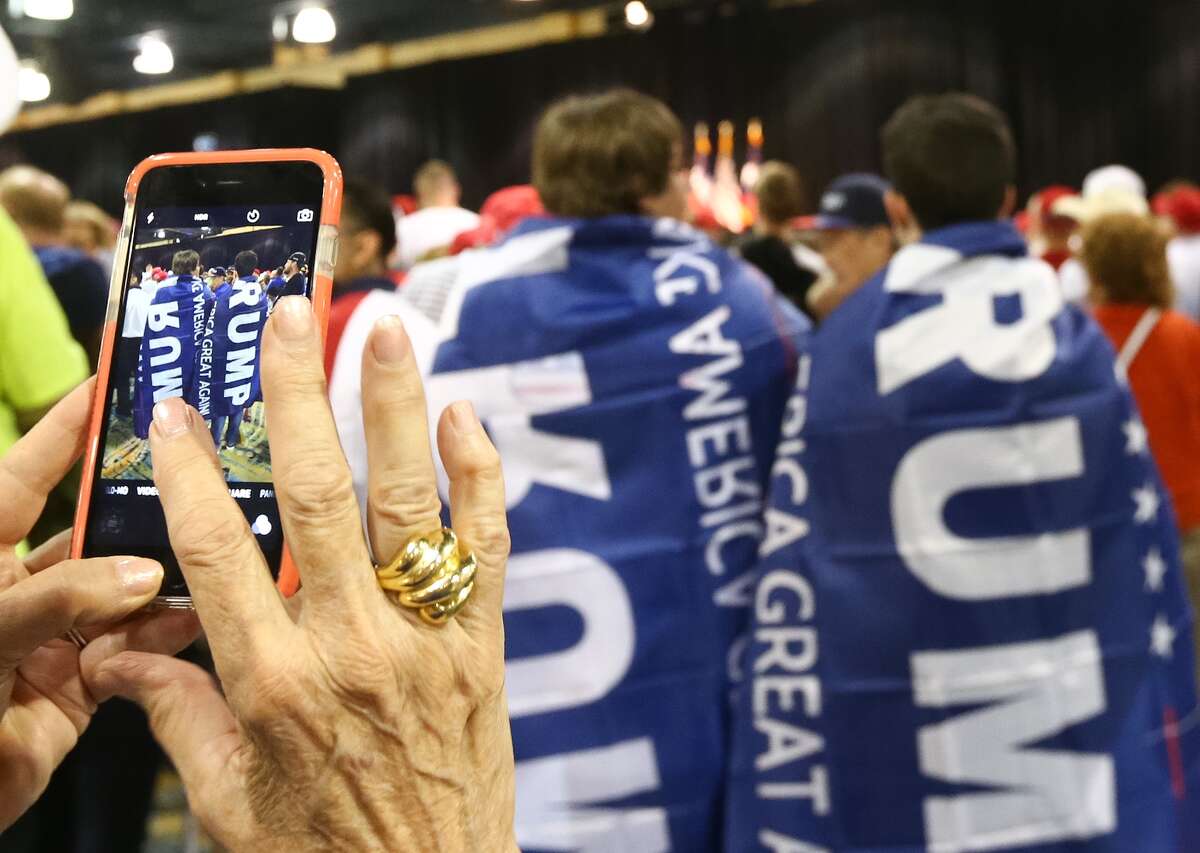 Frances McCarthy takes a picture of Donald Trump supporters before a campaign rally at the Woodlands Waterway Marriott, Friday, June 17, in the Woodlands.