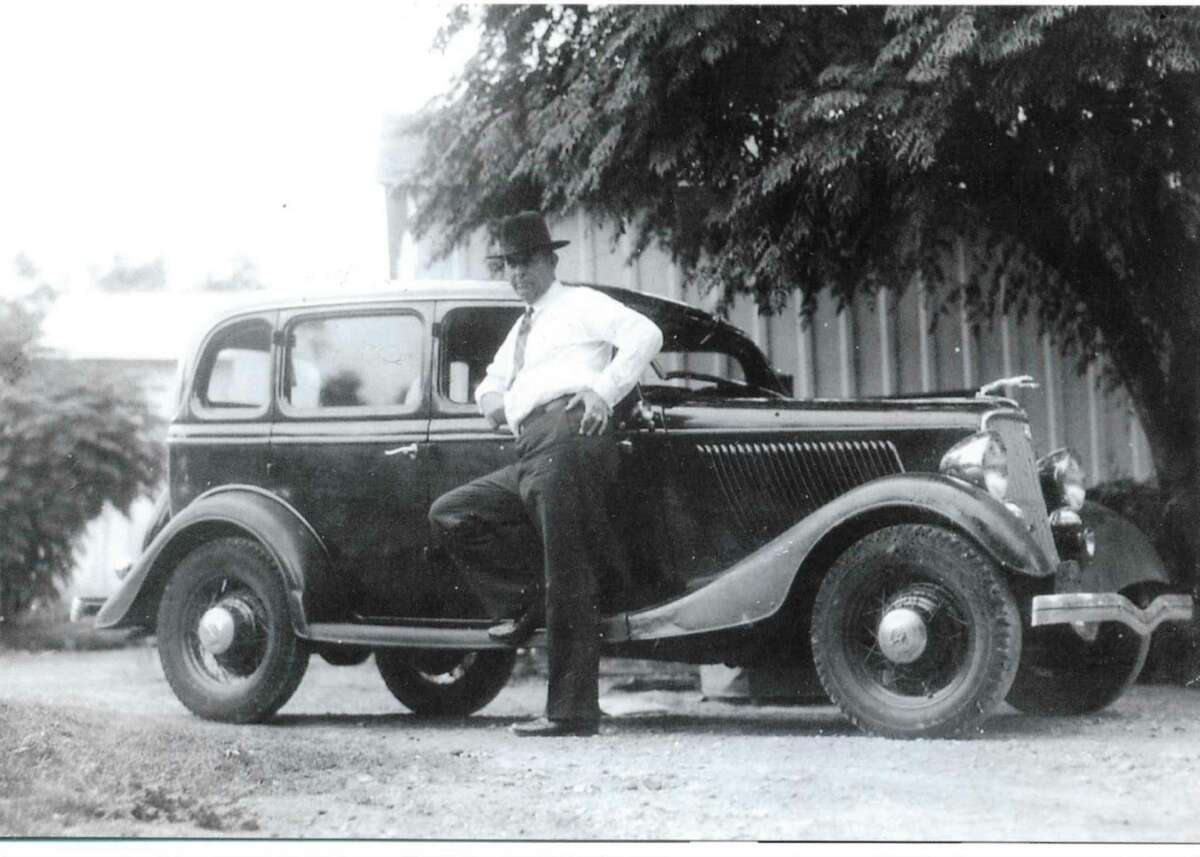 Legendary lawman Frank Hamer stands next to a 1934 Ford after he left the Texas Rangers.