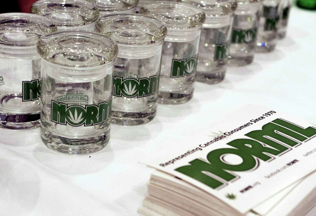 Glass marijuana containers bearing the logo for the National Organization for the Reform of Marijuana Laws, are displayed next to NORML promotional materials at the Cannabis World Congress and Business Exposition, Friday, June 17, 2016 in New York. The three-day conference at New York City's Jacob K. Javits Convention Center was a gathering of professionals and advocates from nearly every facet of the emerging marijuana industry. (AP Photo/Ezra Kaplan)