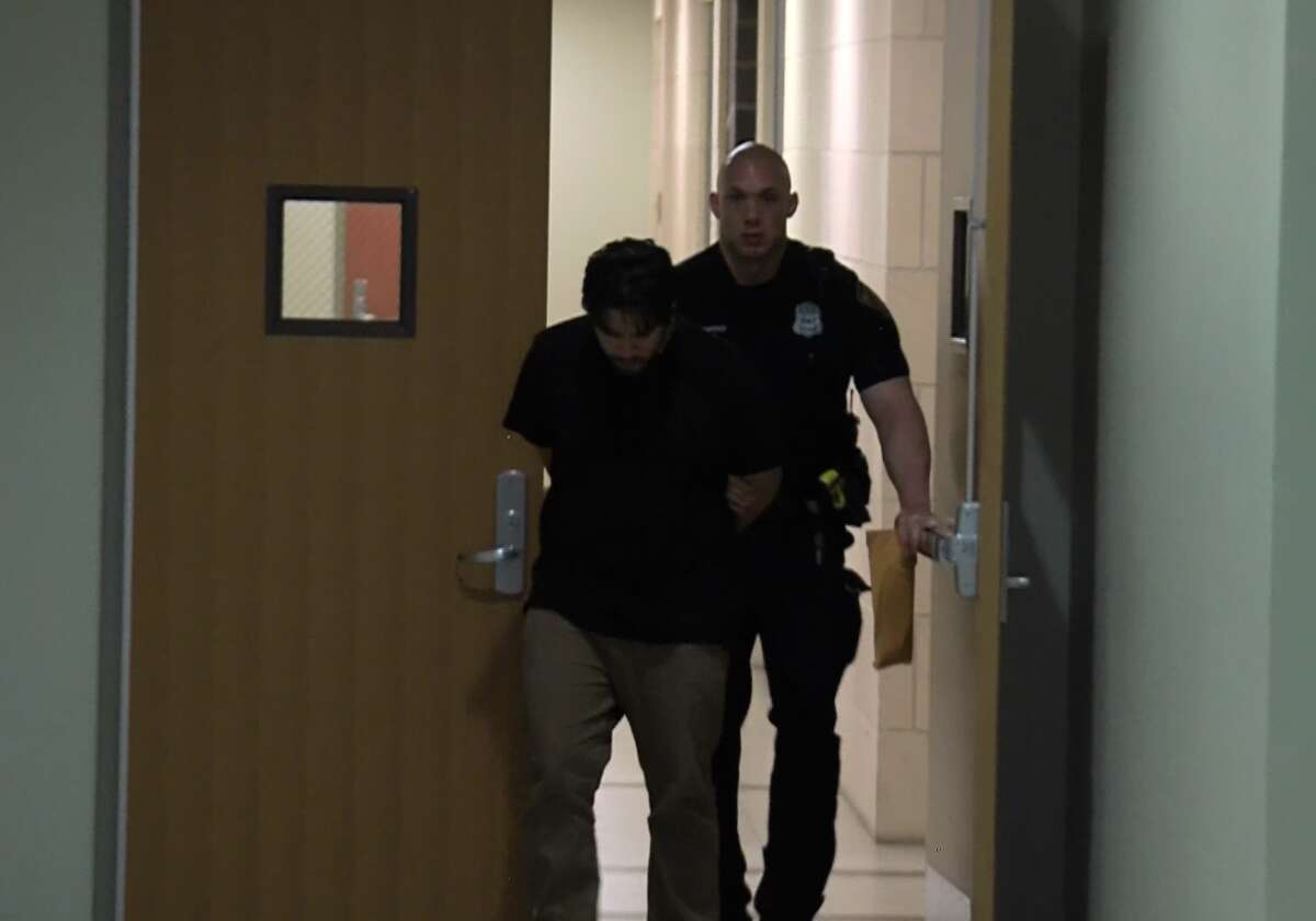 Peter Louis Gonzalez is led away by San Antonio police after being arrested in connection with the June 1 shooting death of 7-year-old Iris Rodriguez.