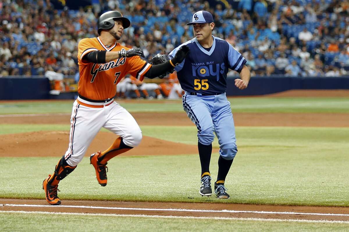 Tampa Bay Rays starting pitcher Matt Moore, right, tags out San Francisco Giants' Gregor Blanco on a sacrifice bunt during the third inning of a baseball game Saturday, June 18, 2016, in St. Petersburg, Fla. (AP Photo/Mike Carlson)