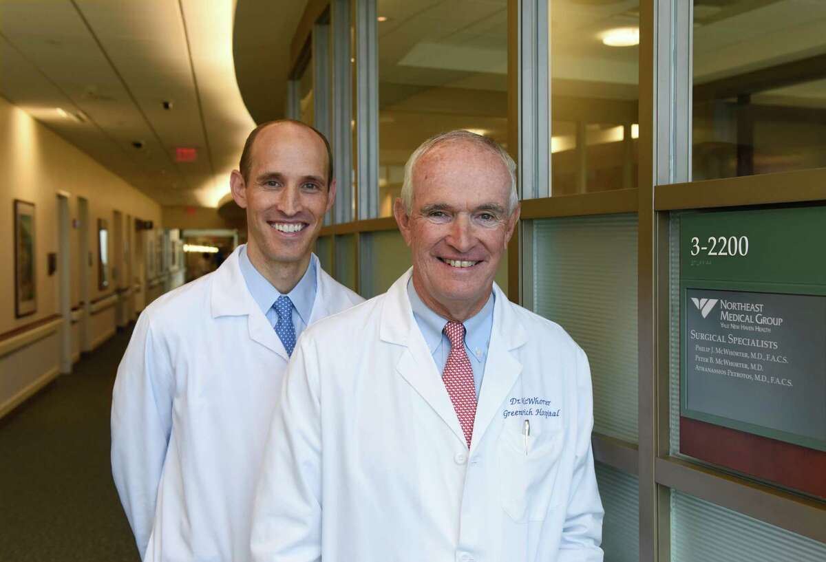 Northeast Medical Group surgical specialists Dr. Peter McWhorter, left, and his father, Dr. Philip McWhorter, at the their practice at Greenwich Hospital. Although Philip did not push Peter to become a doctor, Peter saw his father as a role model and now the two work together at the practice.