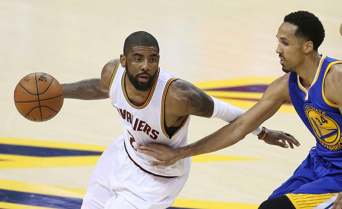 Cleveland Cavaliers guard Kyrie Irving (2) against Golden State Warriors guard Shaun Livingston (34) during the first half of Game 6 of basketball's NBA Finals in Cleveland, Thursday, June 16, 2016. (AP Photo/Ron Schwane)