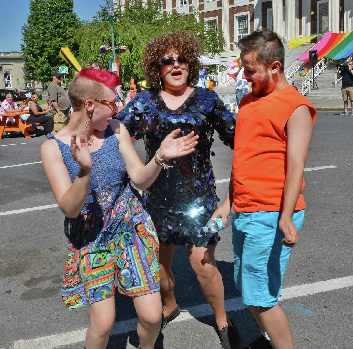 Emma Ward, left, and Victor Negron, dance with Scott Prividera, center, performing as "Dutchess Ivana" at the Schenectady Pride annual Gay Pride festival outside City Hall Saturday June 18, 2016 in Schenectady, NY.(John Carl D'Annibale / Times Union)