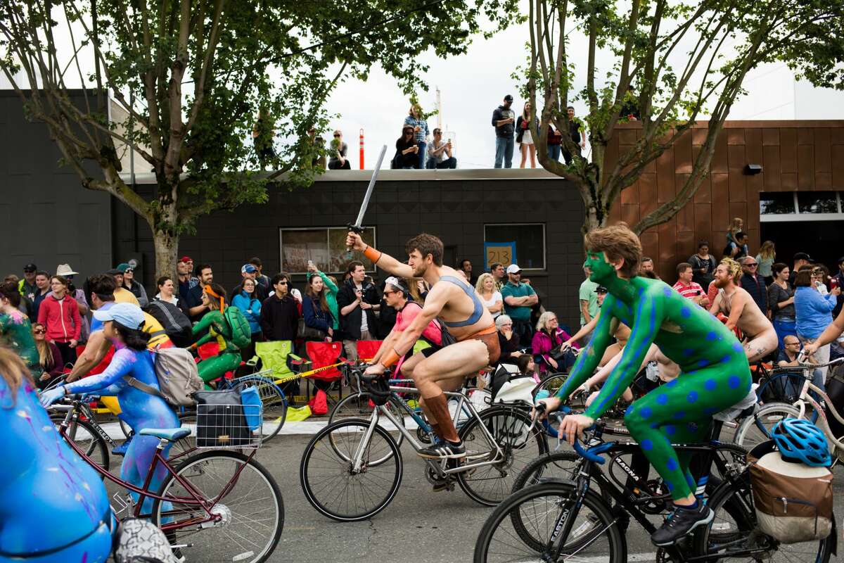 Naked cyclists take to the streets before the Fremont Solstice Parade in Seattle on Saturday, June 18, 2016. The parade, which began in 1989 and celebrates the arrival of Seattle's most treasured season, features a variety of quirky floats, dancers, musicians and, of course, the painted but naked cyclists.