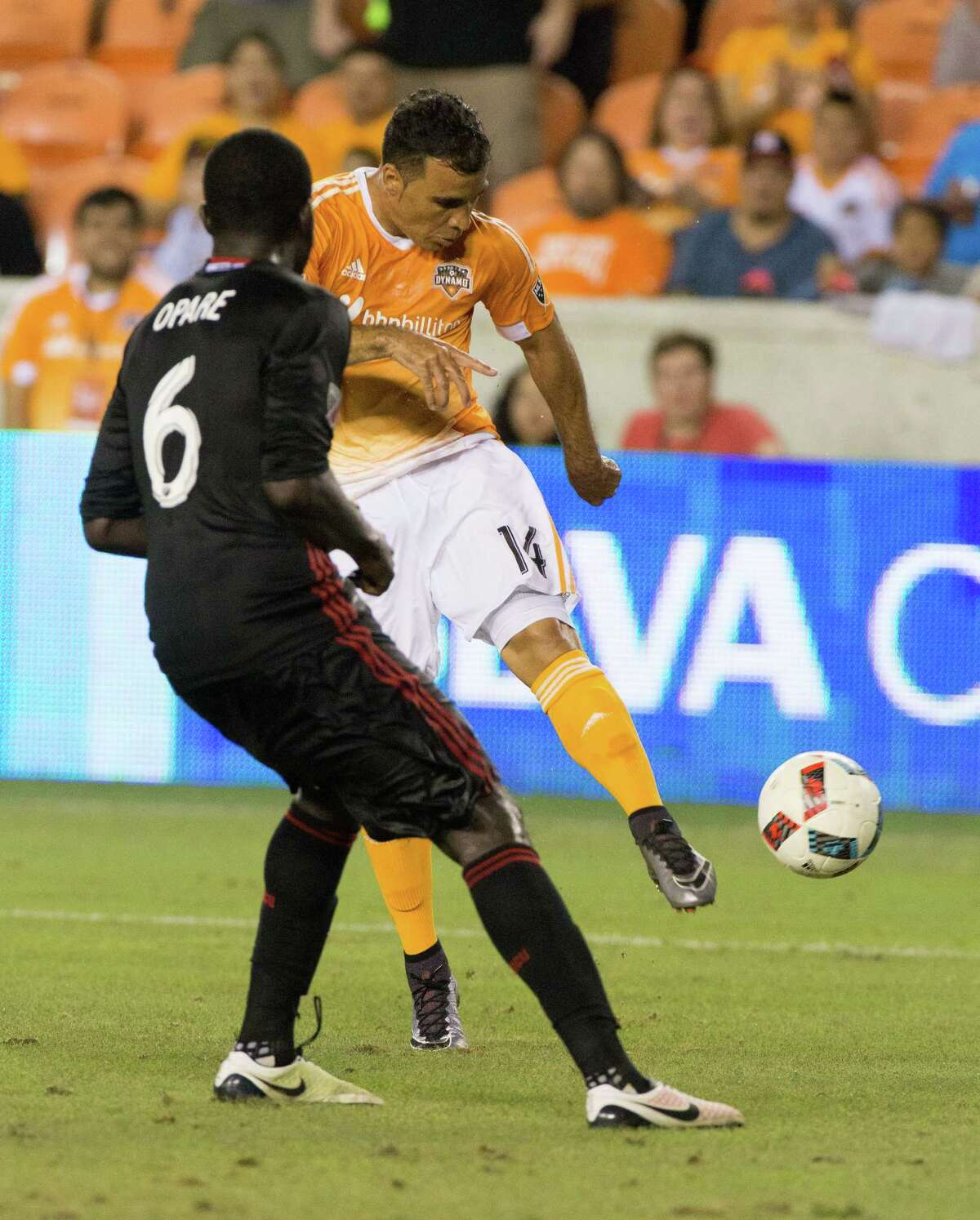 Houston Dynamo midfielder Alex (14) comes up short from kicking a goal in front of D.C. United defender Kofi Opare (6) during the second half of action between the Houston Dynamo and the D.C. United during a soccer game at BBVA Compass, Saturday, June 18, 2016, in Houston. Houston Dynamo tied D.C. United 0-0. ( Juan DeLeon / for the Houston Chronicle )