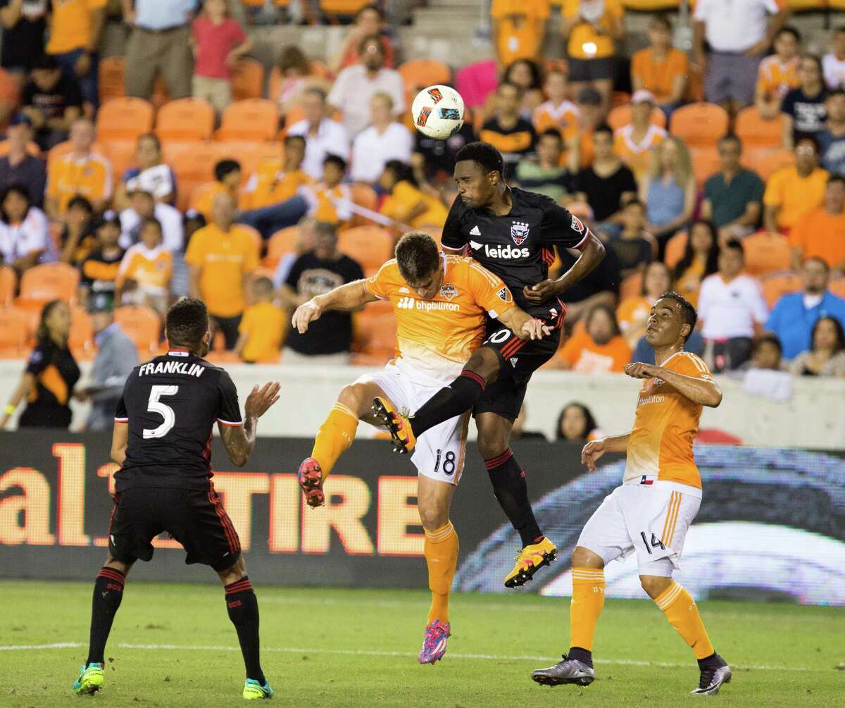 D.C. United forward Fabian Espindola (10) leaps over Houston Dynamo defender David Horst (18) to head but the ball during the second half of action between the Houston Dynamo and the D.C. United during a soccer game at BBVA Compass, Saturday, June 18, 2016, in Houston. Houston Dynamo tied D.C. United 0-0. ( Juan DeLeon / for the Houston Chronicle )