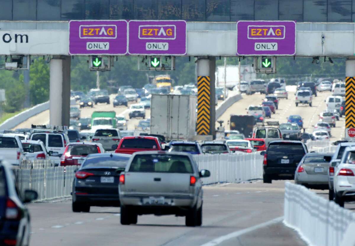 Vehicles pass through EZ TAG lanes on the Sam Houston Tollway on June 16.