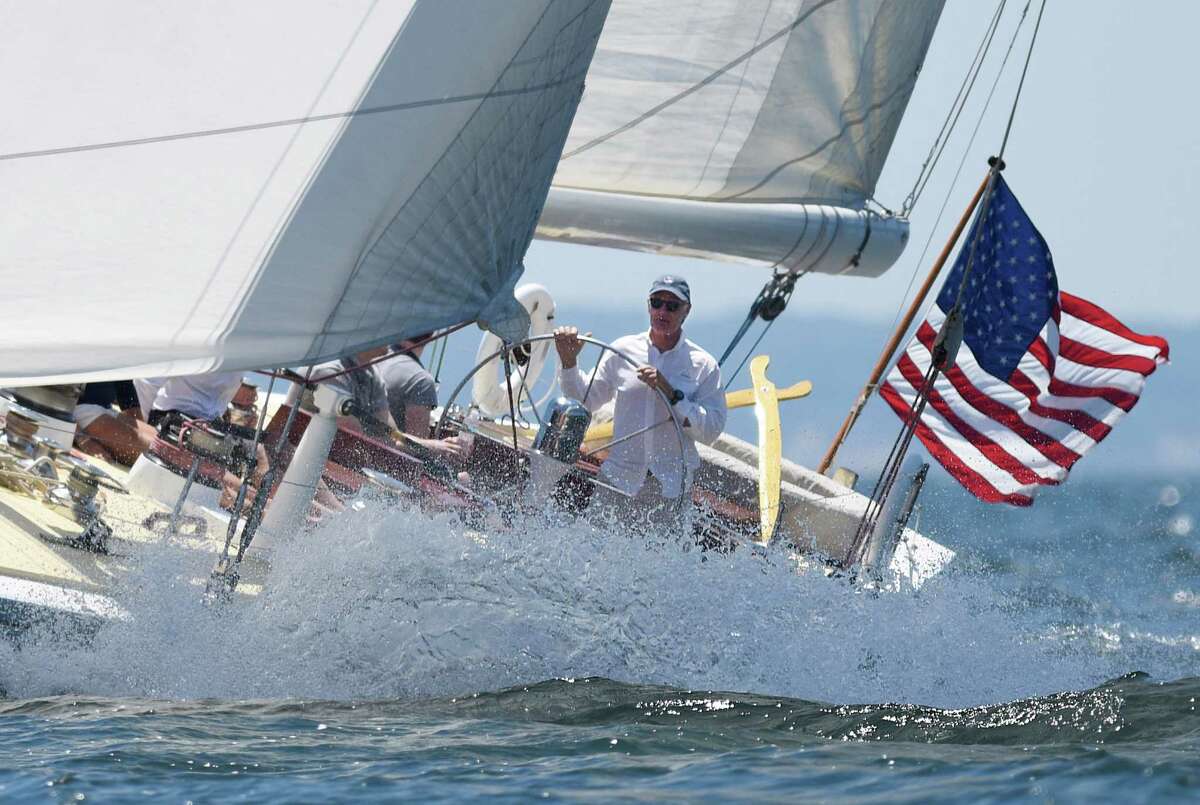 George Hill, of Newport, R.I., captains the Weatherly boat in the Sail to Prevail Belle Haven Challenge Cup in the waters of the Long Island Sound off the shore of Belle Haven Club in Greenwich, Conn. Sunday, June 19, 2016. Twelve disabled veterans from New York and Connecticut served as active crew members on one of the three vintage America's Cup yachts that participated in the competitive sailing races on the Sound. Now in its 18th year, the Challenge Cup allowed the disabled vets to join in competitive camaraderie with Bank of America employees on their boat while competing against two Bridgewater Associates boats.