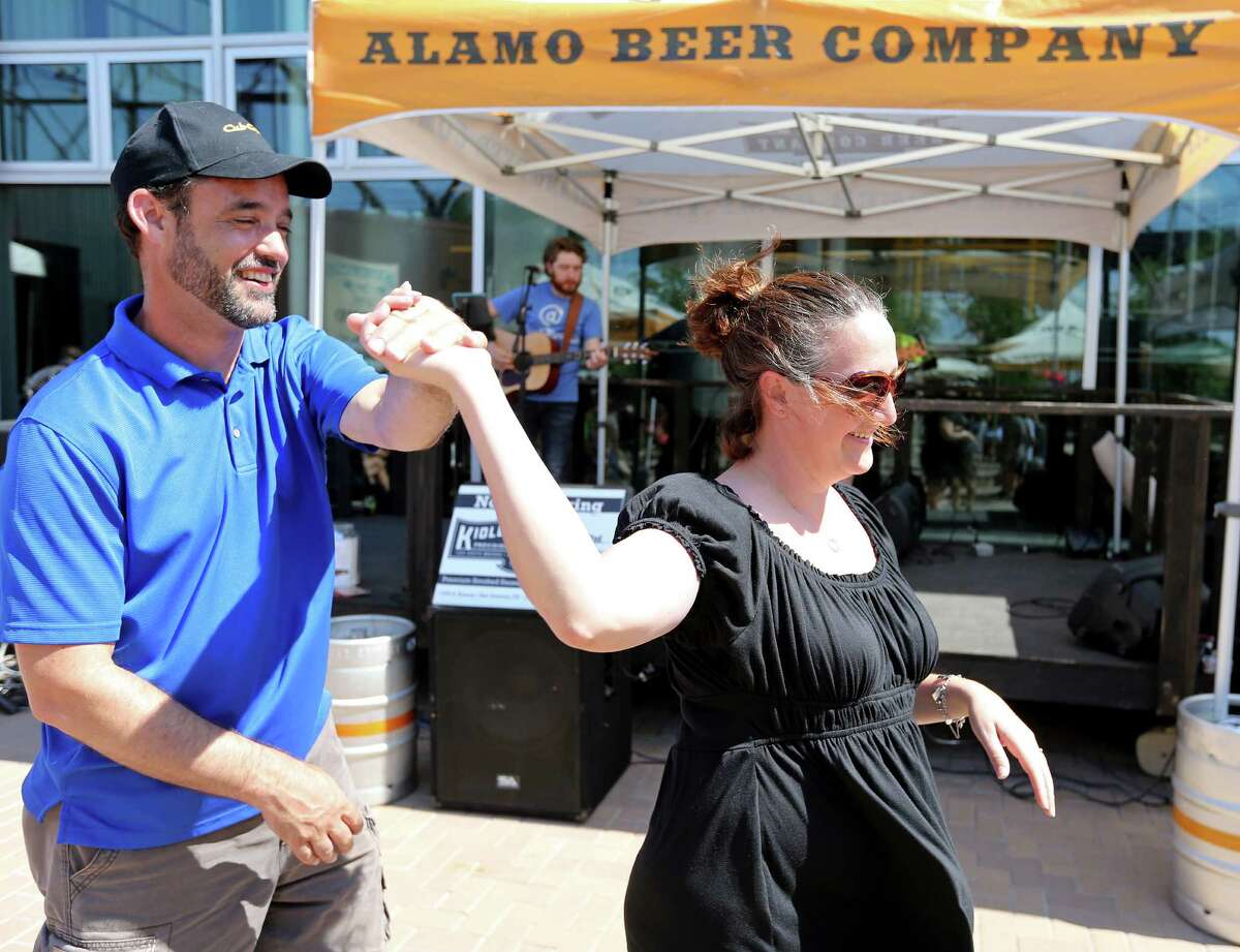 Daniel O’Keefe dances with his fiancee, Sarah Grossenbacher, during FatherFest at the Alamo Beer Co. The highlight of the festival was the Kiolbassa Provision Co. Grillmaster Competition featuring teams consisting of a local dad and a local celebrity.