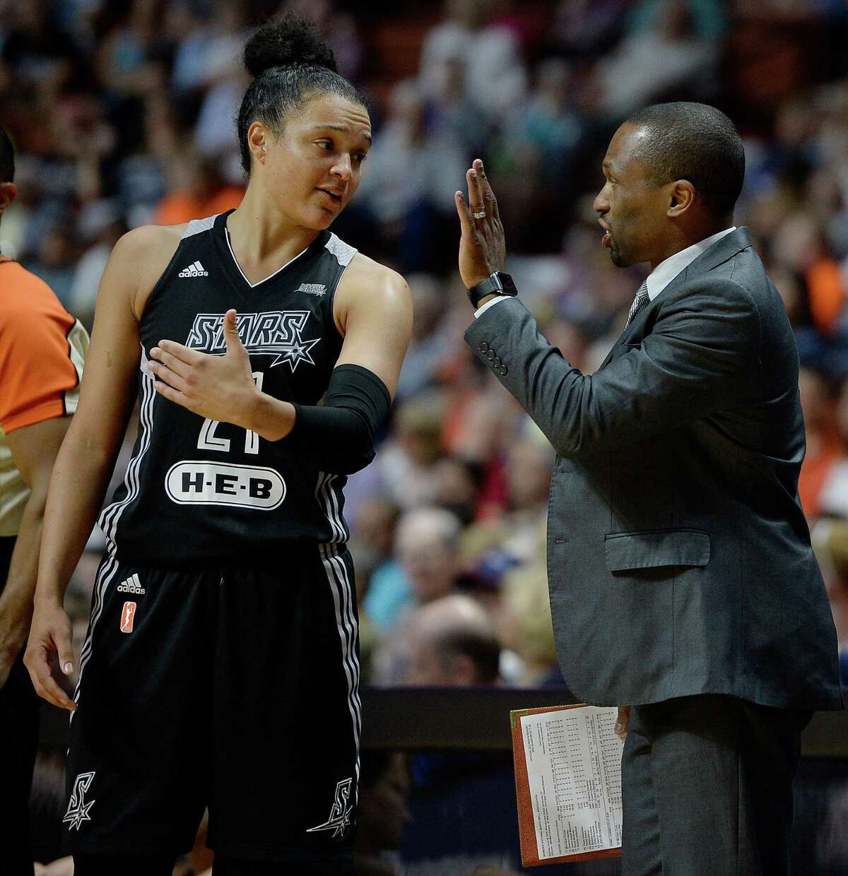 Stars assistant coach James Wade (right) talks with Kayla McBride (left) during the first half on June 19 in Uncasville, Conn.