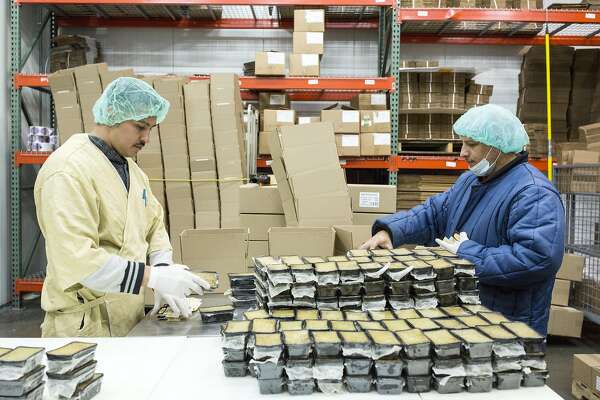 Workers package truffle mousse and prepare it for shipment at Fabrique Delices in Hayward, Calif., on Monday, June 13, 2016. The traditional French charcuterie company makes products such as duck confit and sausage.
