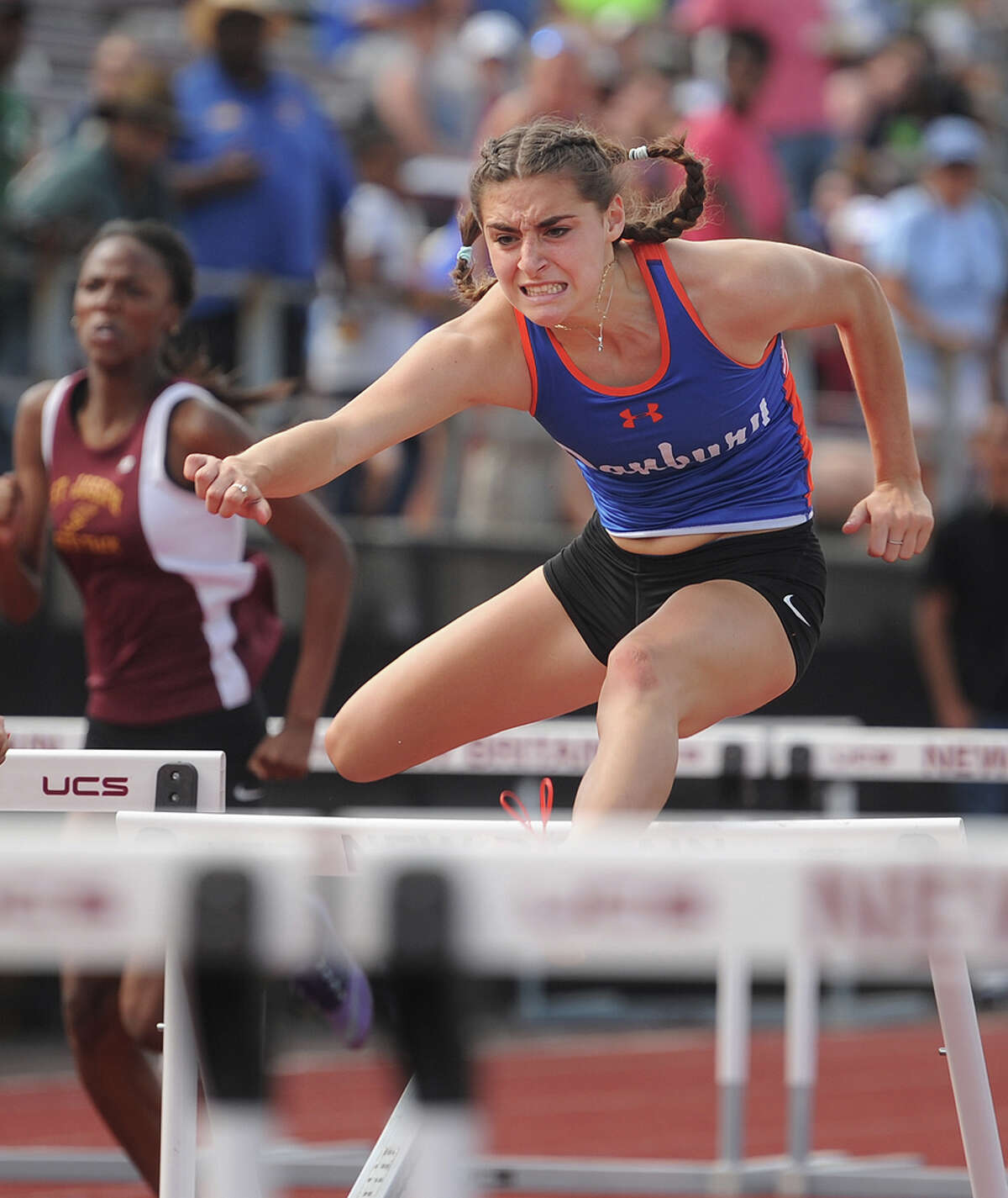FILE PHOTO: Danbury High School's Bridget Chiaravalle, right, races to a second place finish in the 100 meter hurdles at the State Open track championships at New Britain Stadium in New Britain, Conn. on Monday, June 6, 2016.