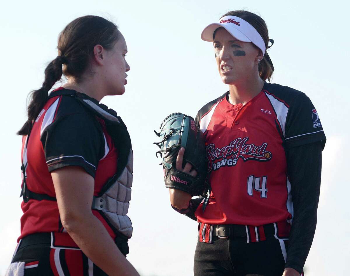 Pitcher Monica Abbott talks strategy with catcher Megan May Whitley before the Scrapyard Dawgs, Houston's new pro softball team, first home game at the Scrap Yard Sports Complex, 29607 Robinson Road in Spring. Photograph by David Hopper