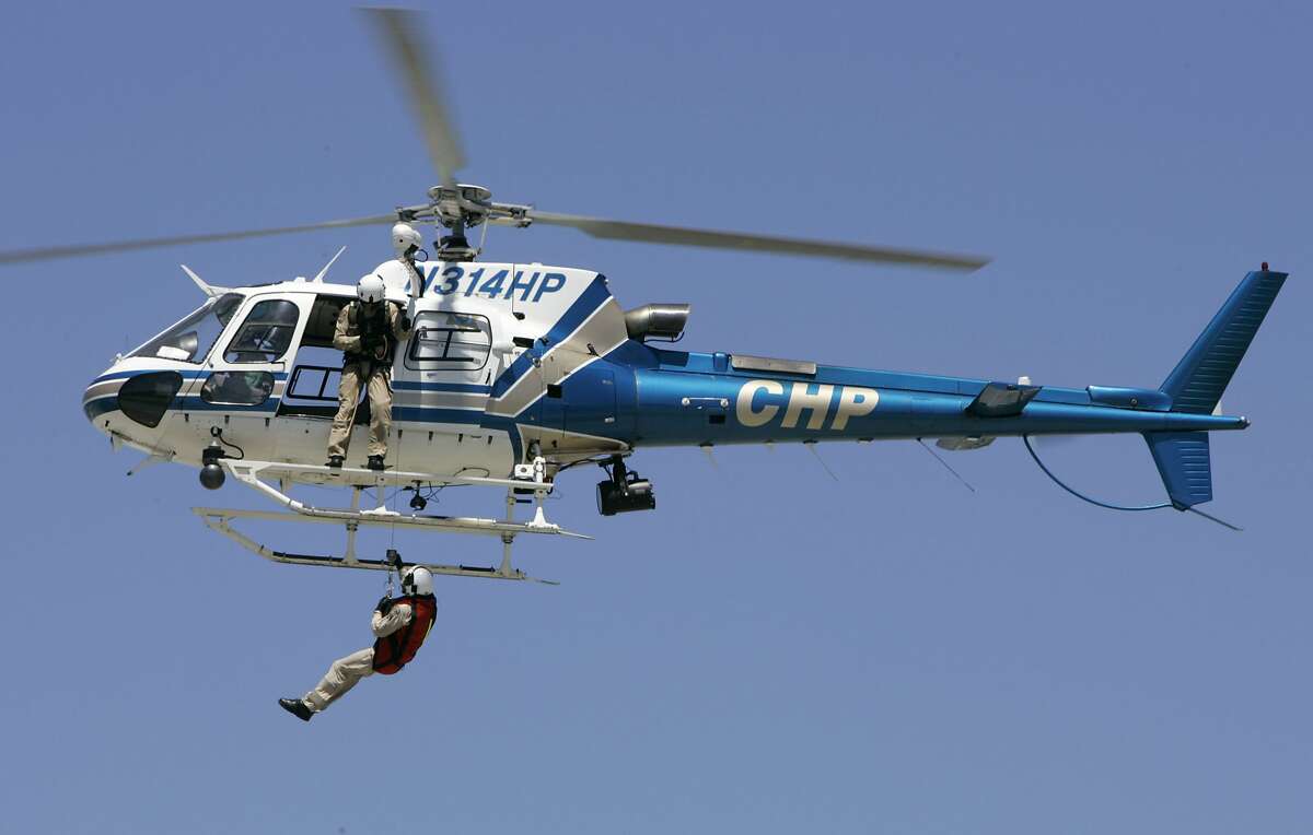 avaitionshow_0002_db.JPG A CHP helicopter based in Napa, pulls a man up from the ground in a demonstration at the "Vertical Challenge Helicopter Show," held at Hiller Aviation Museum next to the San Carlos Airport in San Carlos, CA on Saturday, June 17, 2006. shot: 6/17/06 Darryl Bush / The Chronicle ** (cq)