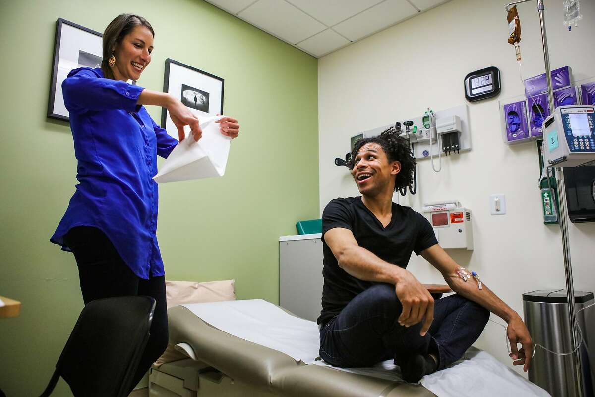 Dr.Aliza Norwood (left) chats with patient Brandon Kazen-Maddox's as he receives an infusion as part of a HIV clinical trial, in San Francisco, California, on Thursday, June 16, 2016.