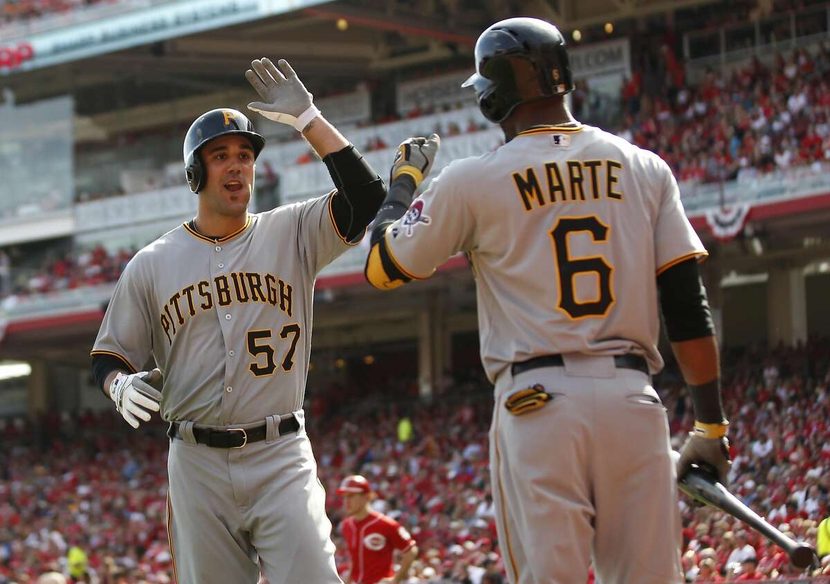 Andrew Lambo #57 celebrates with Starling Marte #6 of the Pittsburgh Pirates after hitting a solo homerun against the Cincinnati Reds at Great American Ball Park on September 28, 2013 in Cincinnati, Ohio. (Photo by John Sommers II/Getty Images)