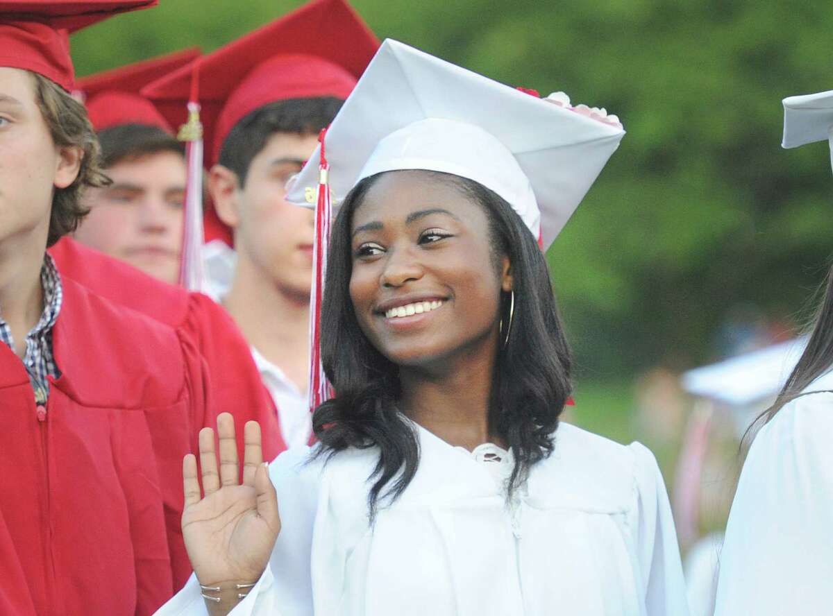 Saint Joseph's University bound Zyanna Almonacy, 18, waves to her parents just before receiving her diploma during the Greenwich High School commencement ceremony at the school in Greenwich, Conn., Tuesday, June 21, 2016.
