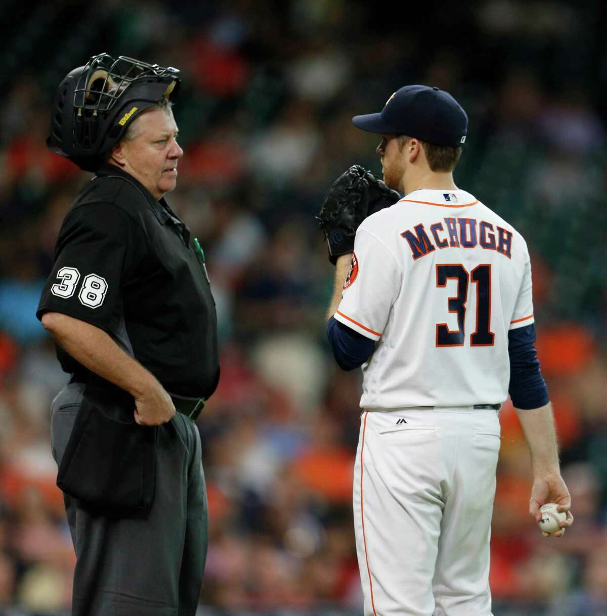 Houston Astros starting pitcher Collin McHugh (31) talks to home plate umpire Gary Cederstrom after Los Angeles Angels right fielder Kole Calhoun (56) singled during the third inning of an MLB baseball game at Minute Maid Park, Tuesday, June 21, 2016, in Houston.