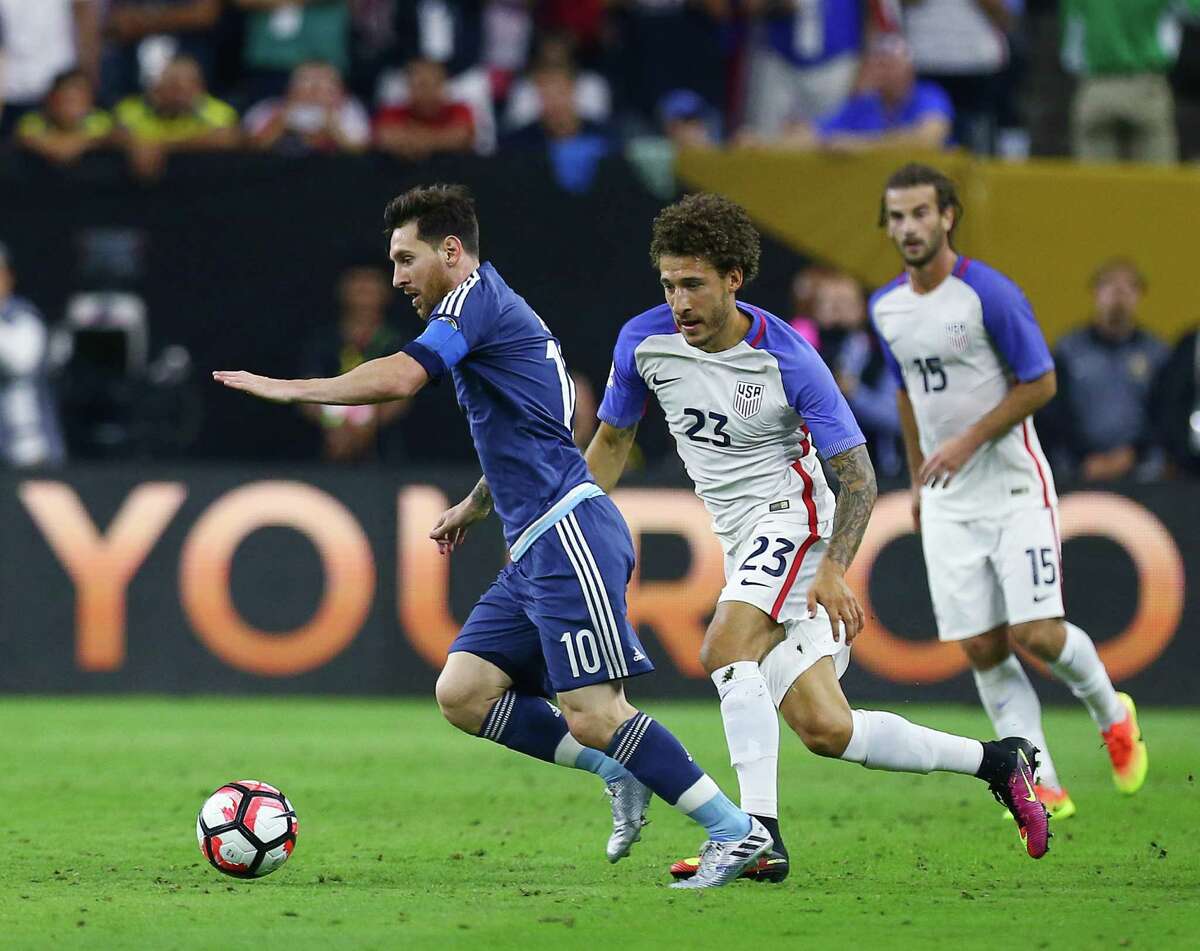 Argentina midfielder Lionel Messi (10) drives the ball downfield against United States defender Fabian Johnson (23) during the first half of a COPA America semi-final game at NRG Stadium, Tuesday, June 21, 2016, in Houston.