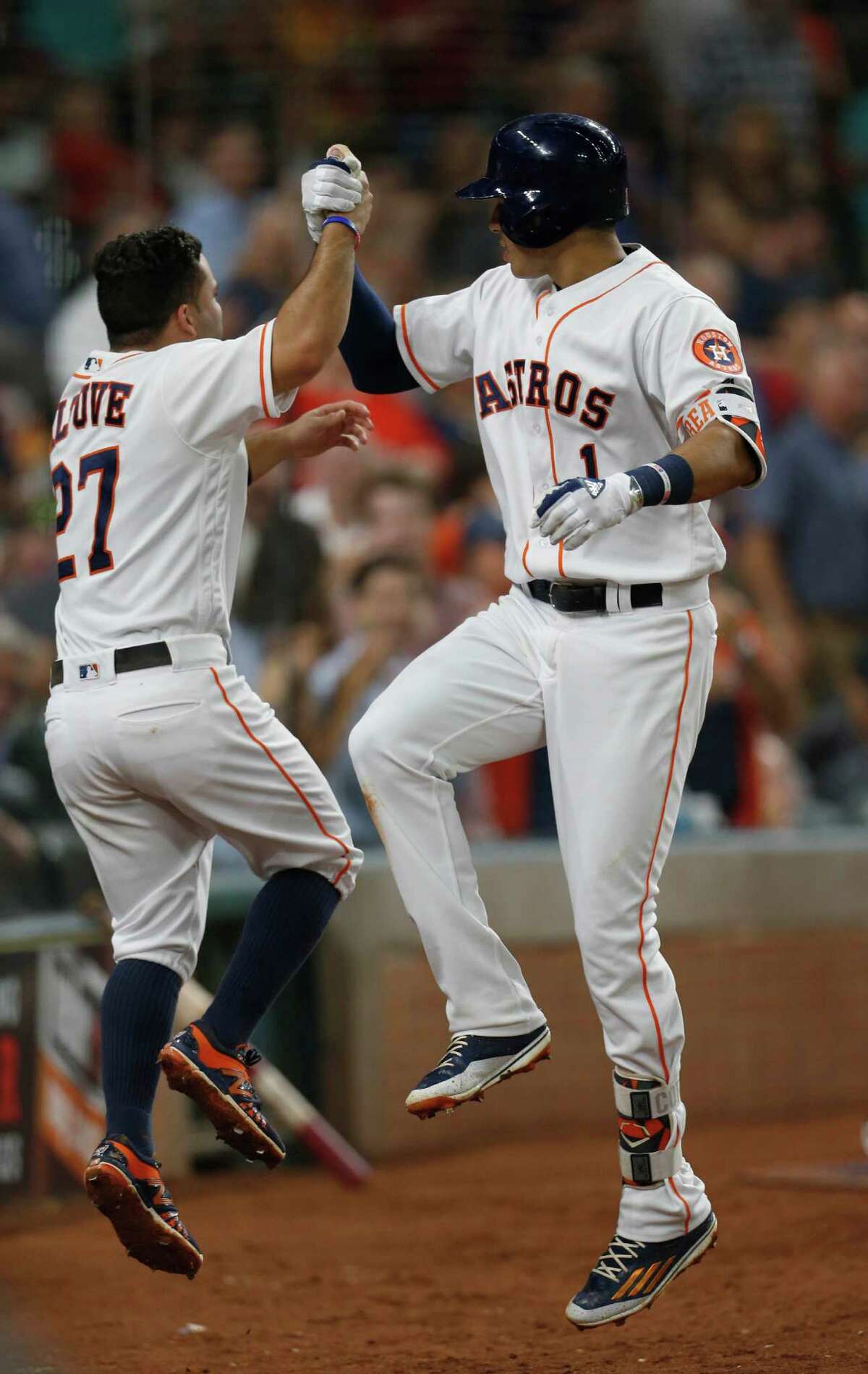 Carlos Correa (1), whose single won it in the ninth, celebrates his fifth-inning homer with Jose Altuve.