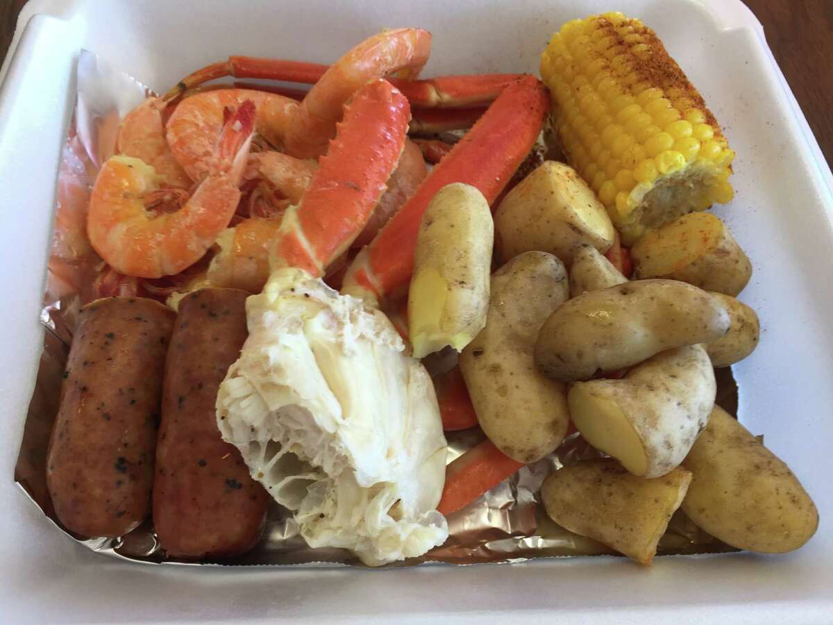 Sunny Florida at The San Antonio Crab Shack: snow crab, shrimp, fingerling potatoes, smoked sausage, corn on the cob and a small ramekin of a flavored butter for dipping.