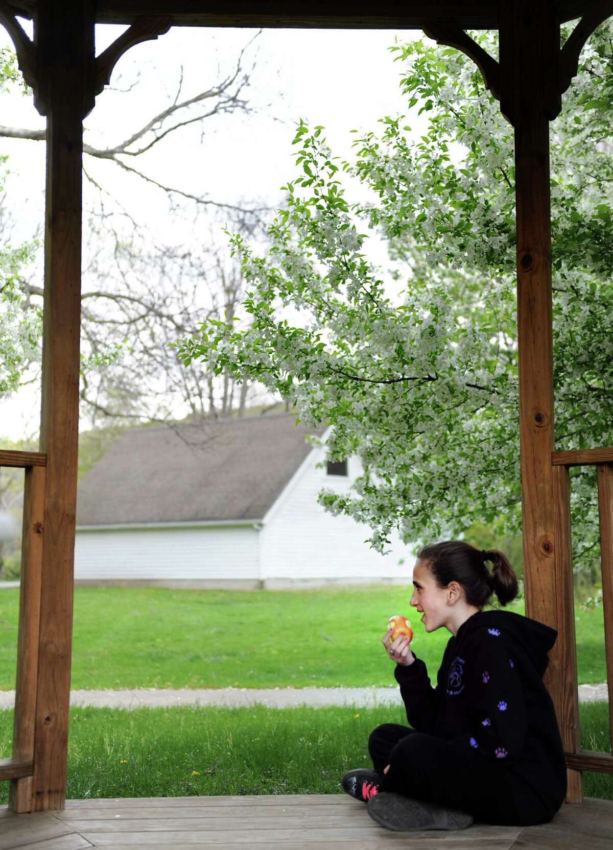 Thirteen-year-old Emma Hue, an 8th-grade-student at Whisconier Middle School in Brookfield, eats her lunch under the gazebo at the Kellogg Environmental Center Wednesday, April 25, 2012 following a field trip to the center in Derby. The trip was part of Project CLEAR (Candlewood Lake Environmental Awareness and Responsibility) which teaches 125 middle and high school students how to be citizen scientists. Students explored Osbornedale State Park, testing water quality and discerning between native and invasive birds.
