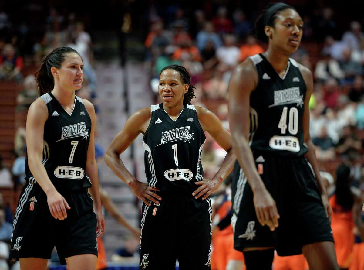 Stars’ Monique Currie (center) reacts at the end of the first half as teammates Haley Peters (left) and Kayla Alexander walk off the court during a WNBA game against the Connecticut Sun on June 19, 2016, in Uncasville, Conn.