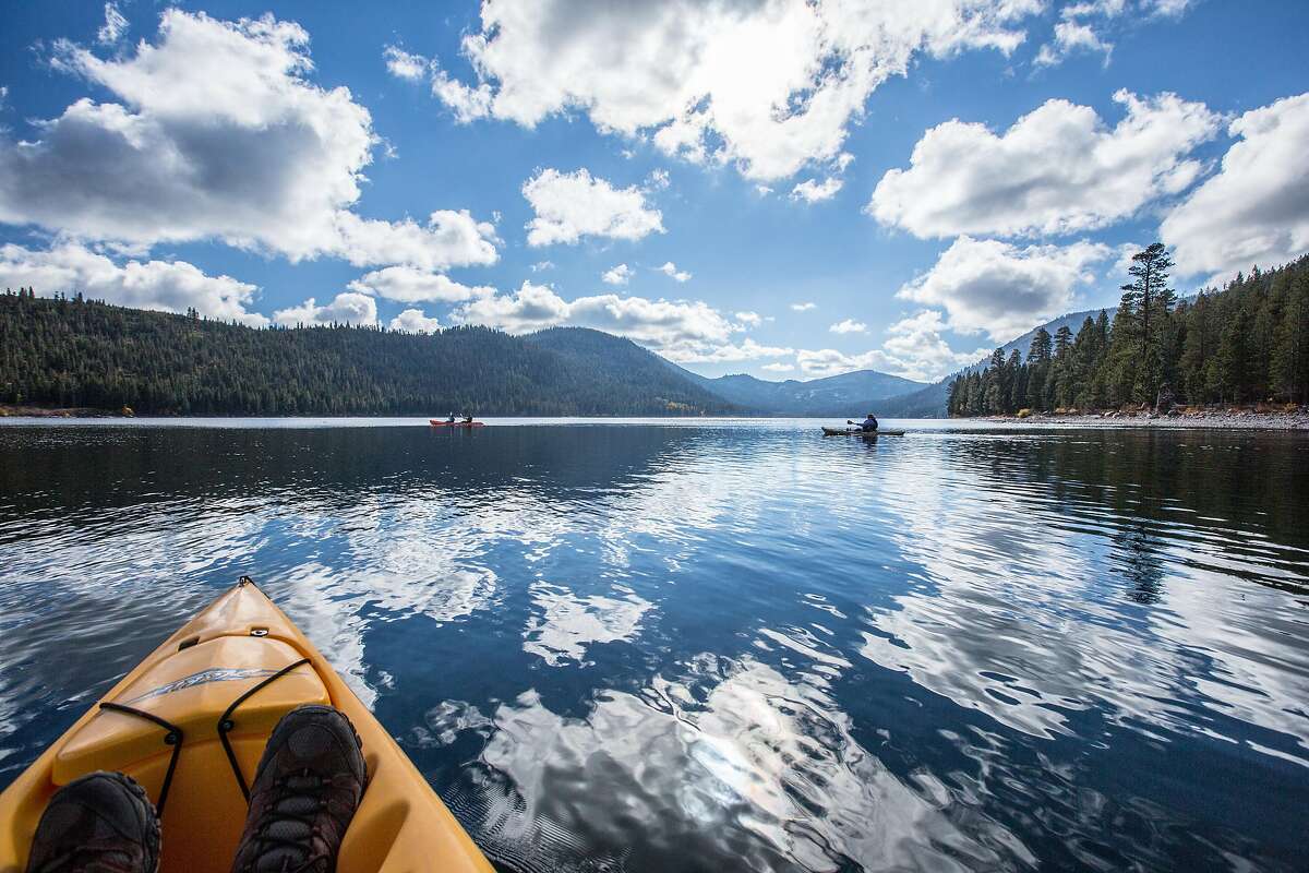 Kayakers paddle across pristine waters of Independence Lake, located north of Truckee northwest of Tahoe in the Sierra Nevada