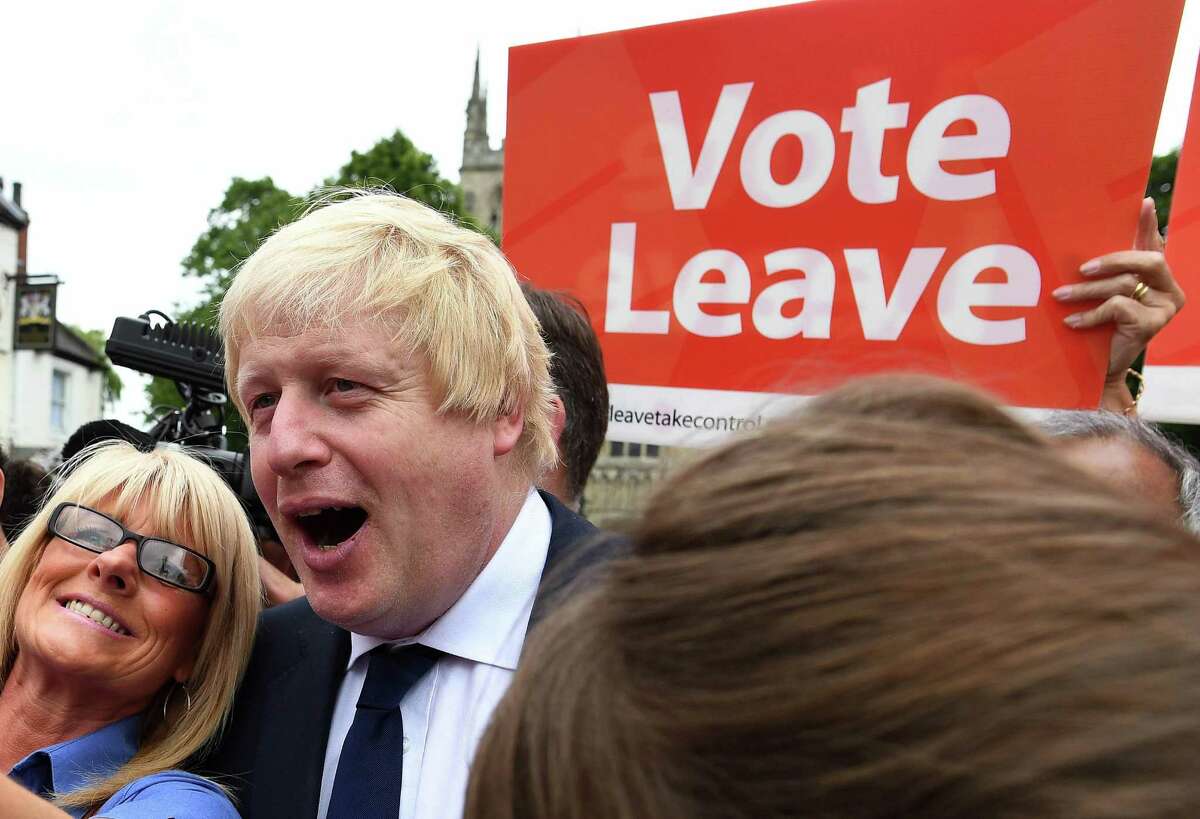“Leave”-EU advocate Boris Johnson poses for a photo with voters in Selby, England, on the final day of campaigning before Britain’s referendum. Polls suggest the vote could go either way.