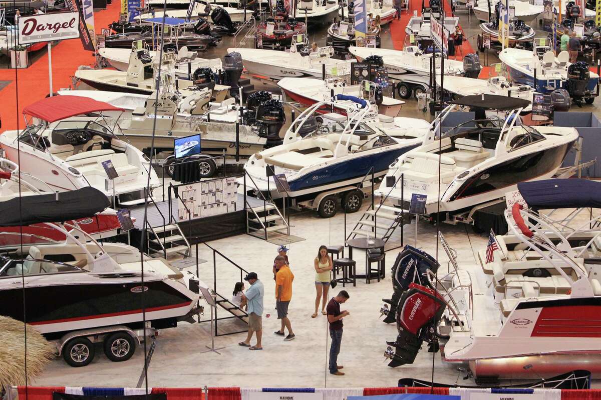 Attendees at the Houston Summer Boat Show look over the latest available boats, cruisers, runabouts, pontoons, kayaks, wakeboard boats, fishing gear, accessories, boating electronics, patio furniture, clothing, jewelry and more Wednesday, June 22, 2016, in Houston. ( Steve Gonzales / Houston Chronicle )