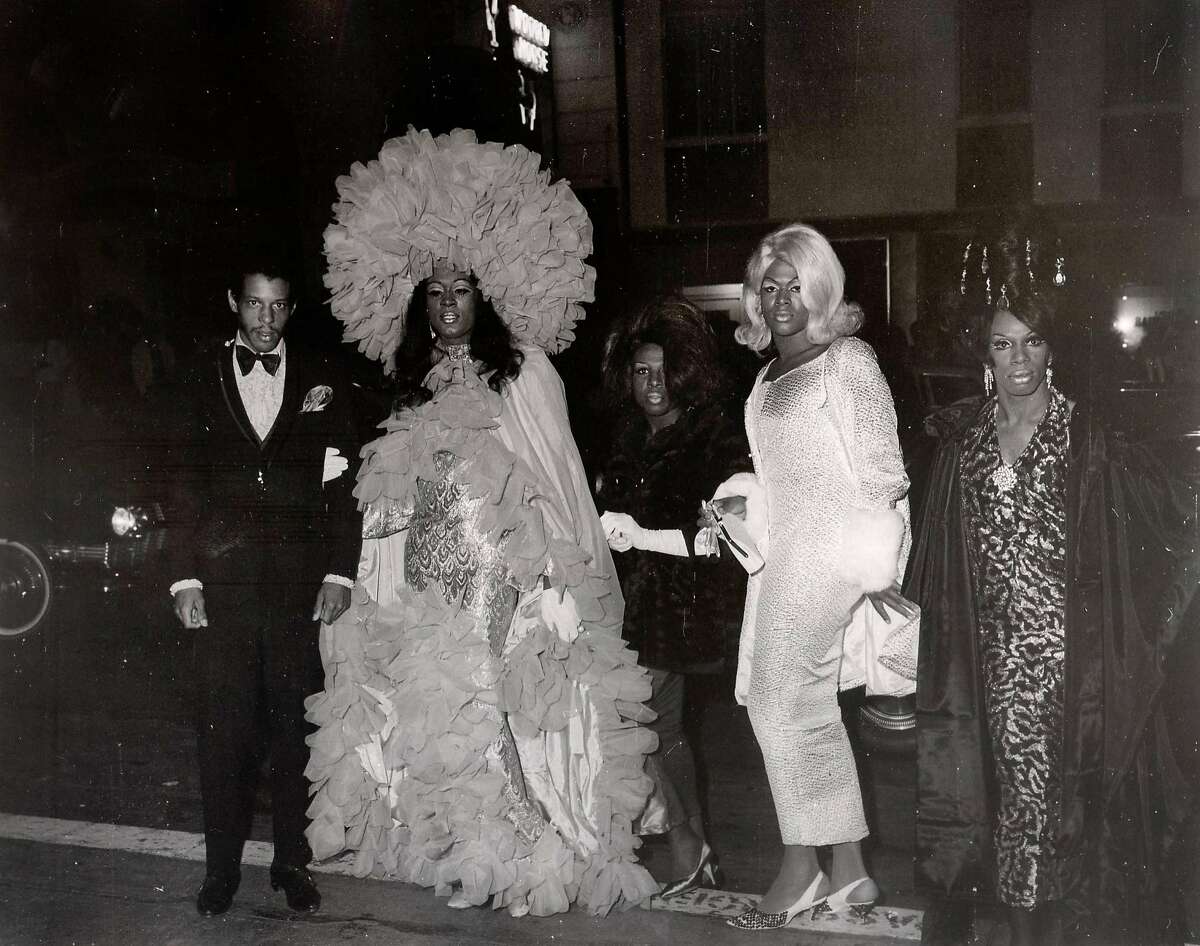 A photo circa 1965 of people arriving at a drag ball. Events like these were held by the Imperial Court of San Francisco. At the time, it was illegal to dress as women and the most vulnerable were frequently harassed by the police.