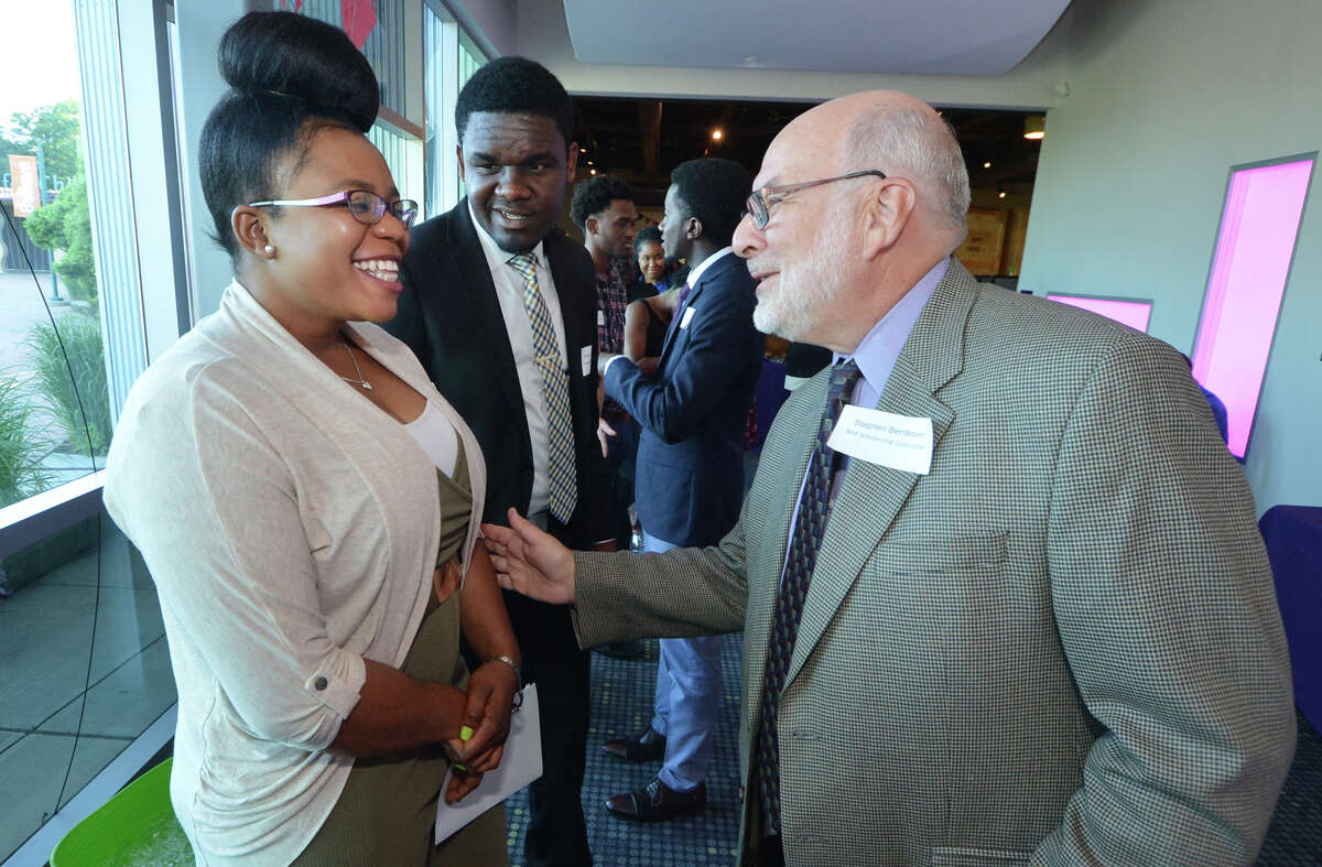 Edna Hilaire is congratulated by scholarship committee member Stephen Bentkover during the Norwalk Housing Foundation 18th Annual Scholarship Awards Ceremony at Stepping Stones Museum for Children on Wednesday June 22, 2016 in Norwalk Conn.