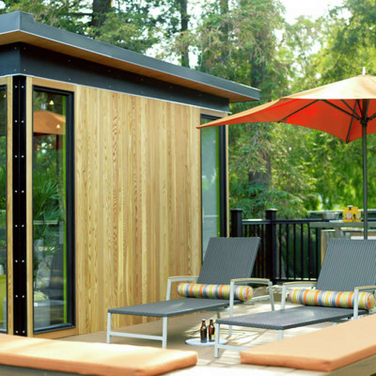Guest lounge The TimberTech deck around this prefab guest house creates a variety of outdoor destinations, including a barbecue kitchen and lounge area. On the other side of the structure, the deck connects the guest suite with an outdoor shower and a small office. See more of this modern cottage