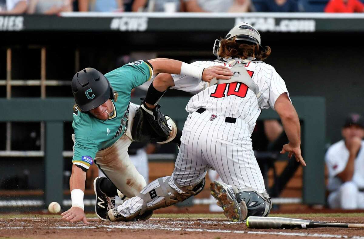 Coastal Carolina's Zach Remillard reaches to score around Texas Tech catcher Tyler Floyd (16) as the ball gets away at home plate in the third inning of an NCAA College World Series baseball game in Omaha, Neb., Thursday, June 23, 2016. Remillard was safe. (AP Photo/Ted Kirk) ORG XMIT: NEPS115