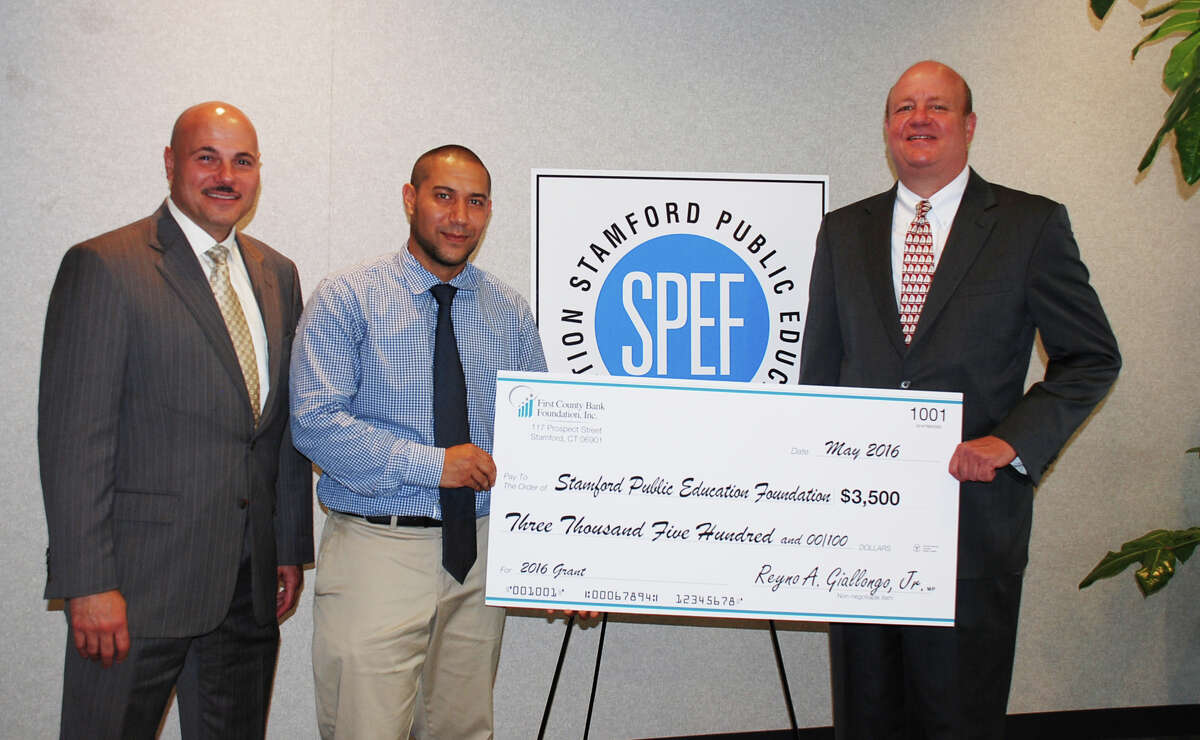 First County Bank's Willard Miley and Mark Rosenbloom present Matthew Quinones, center, CEO of the Stamford Public Education Foundation, with a $3,500 grant to help fund the group’s nationally-recognized mentoring program.