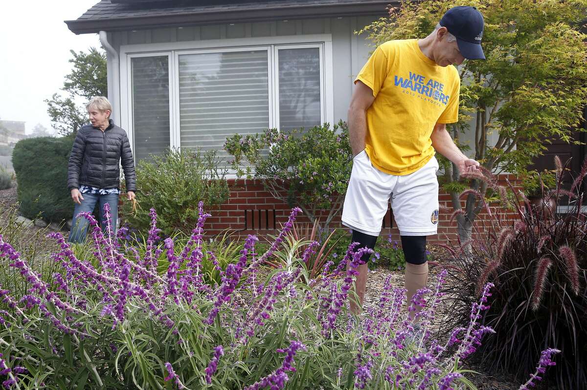 Amy and Steve Tessler work in their water-saving front yard in Oakland, Calif. on Friday, June 24, 2016. The Tesslers have cut about 66 percent off their water bill since converting to drought resistant landscaping and received rebates from EBMUD to defray the costs of the conversion.