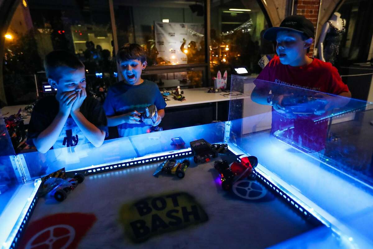 (l-r) Declan McLaughlin, 9, Clive Potter, 8, and Edward Loski,11, compete against one another in a robot game, called Bash Bots, while attending a watch party for the television show "Battle Bots", at Autodesk offices, in San Francisco, California, on Thursday, June 23, 2016.