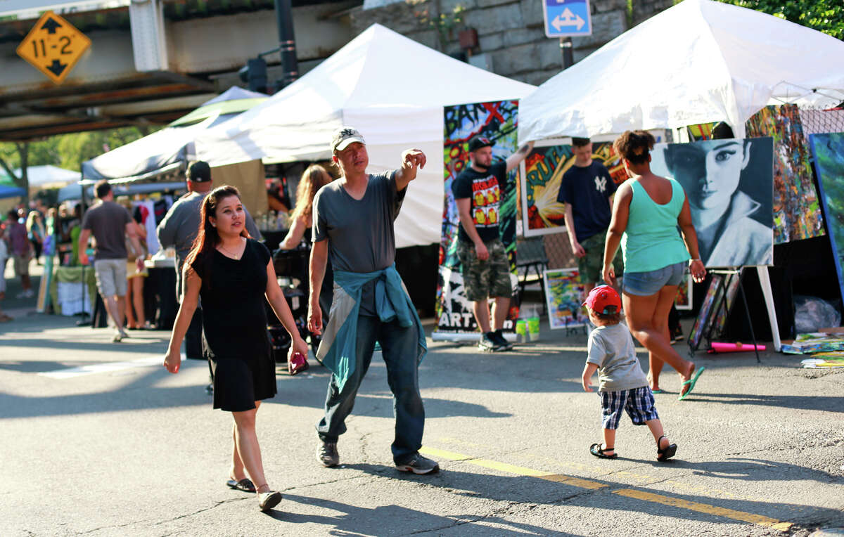 Festival-goers walk down Washington Street at the SoNo Arts Festival in 2015.
