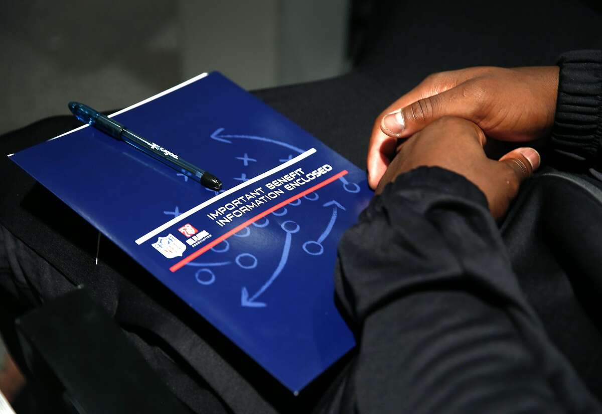 A rookie holds a packet of information at an orientation session for incoming players at Oakland Raiders team headquarters in Alameda, Calif. on Friday, June 24, 2016.