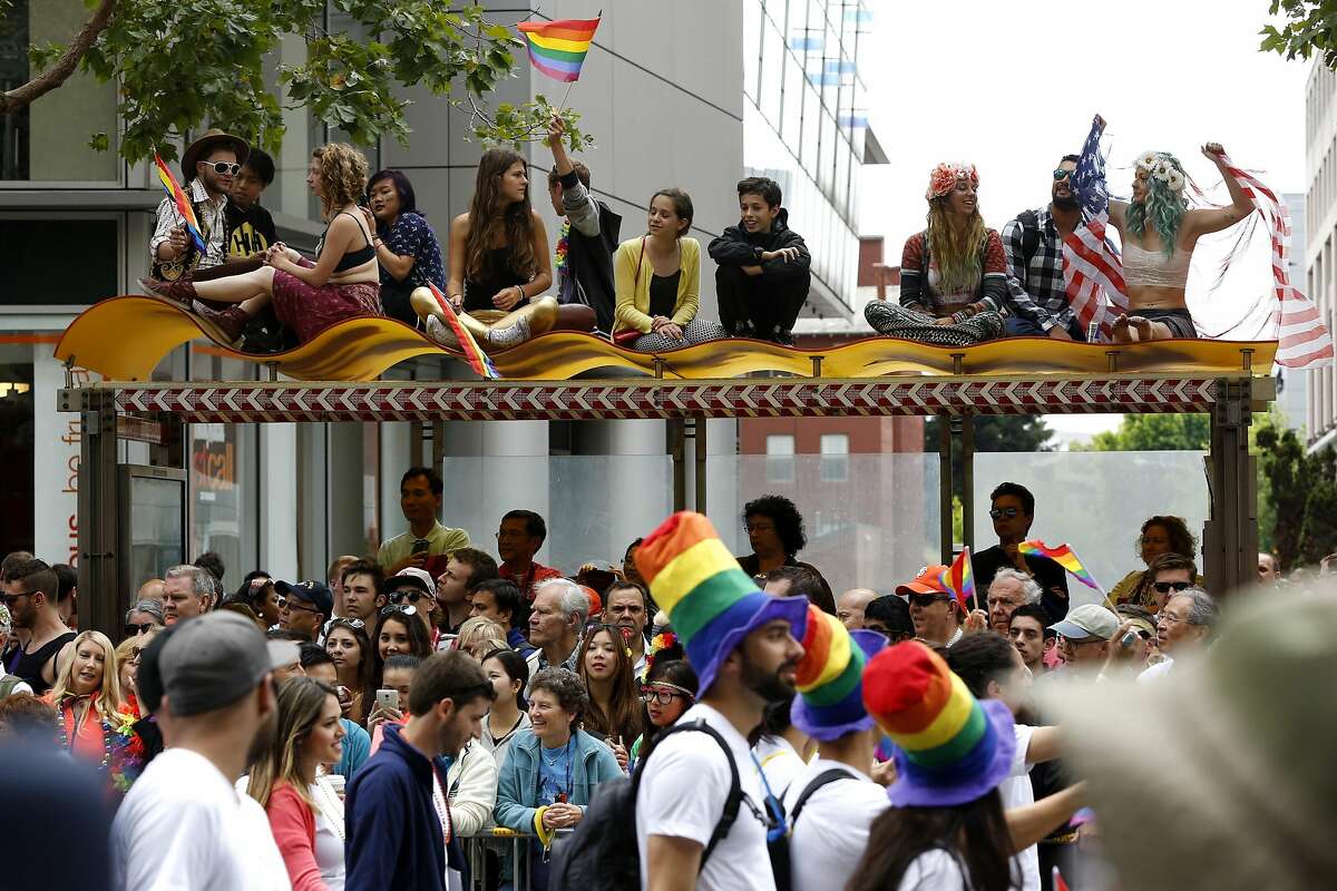 People sat and stood anywhere they could to see the SF Pride parade in San Francisco, California, on Sunday, June 28, 2015.