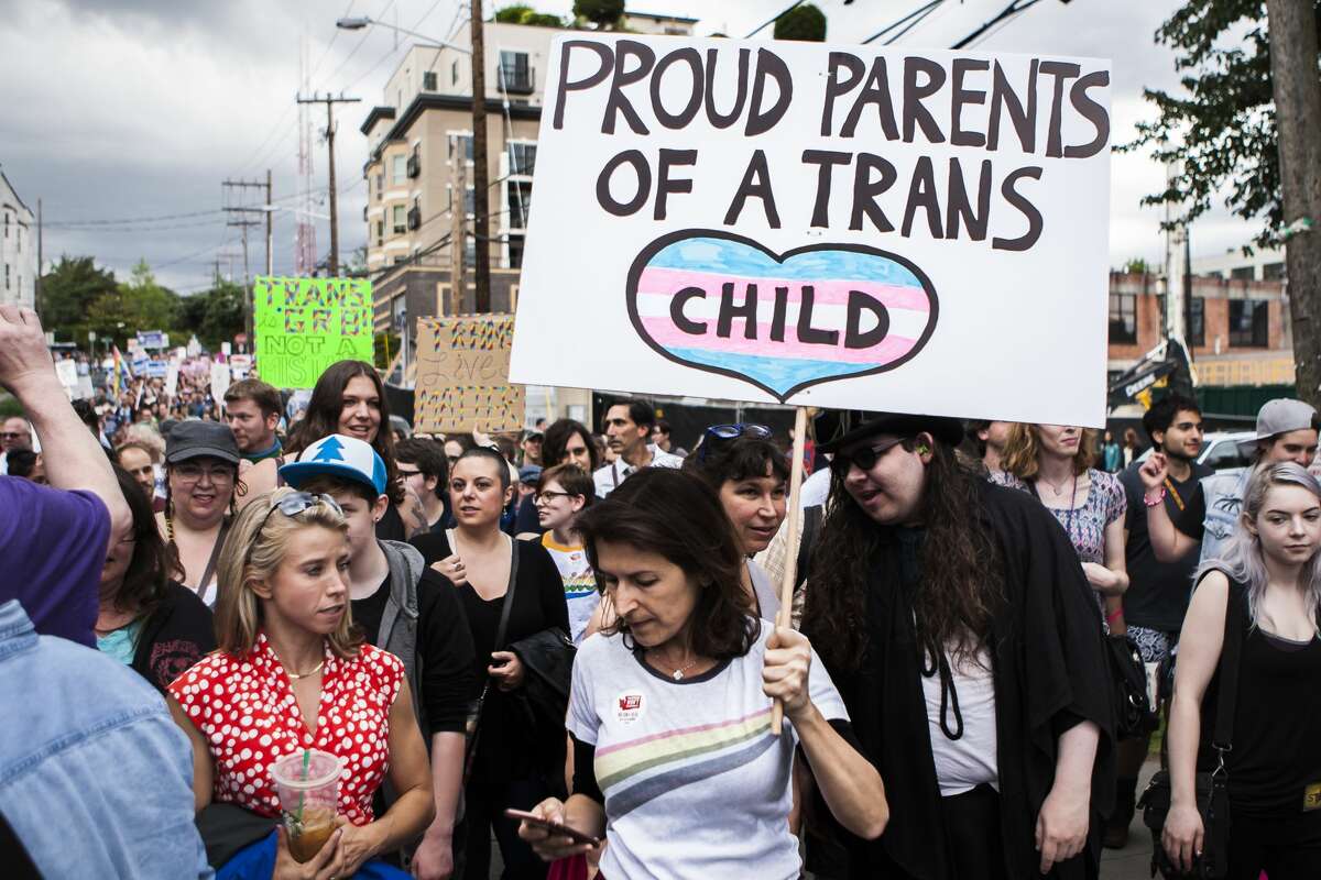 A mother holds a sign in support of her transgender child near the end of the Trans Pride March at Cal Anderson Park in downtown Seattle on June 24, 2016. (Lacey Young, seattlepi.com)