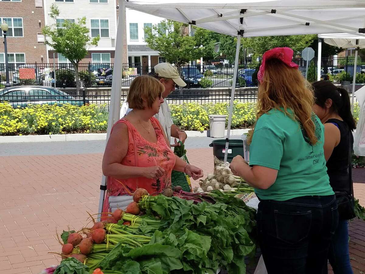 Customers enjoyed a selection of fresh produce at the opening of the Danbury Farmers Market in Kennedy Park on Sat., June 25, 2016.