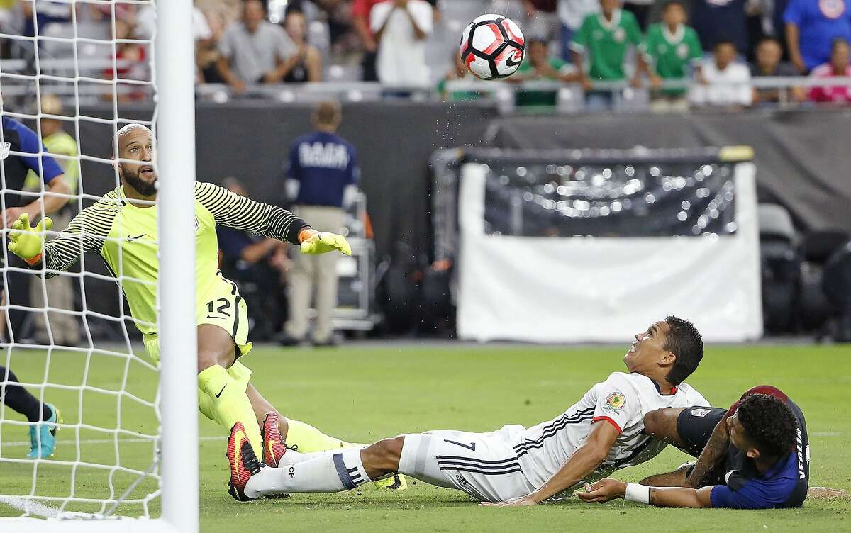 Colombia's Carlos Bacca (7) sends the ball past United States goalie Tim Howard (12) for a goal as United States' DeAndre Yedlin, right, defends during the first half of the Copa America Centenario third-place soccer match Saturday, June 25, 2016, in Glendale, Ariz. (AP Photo/Ross D. Franklin)