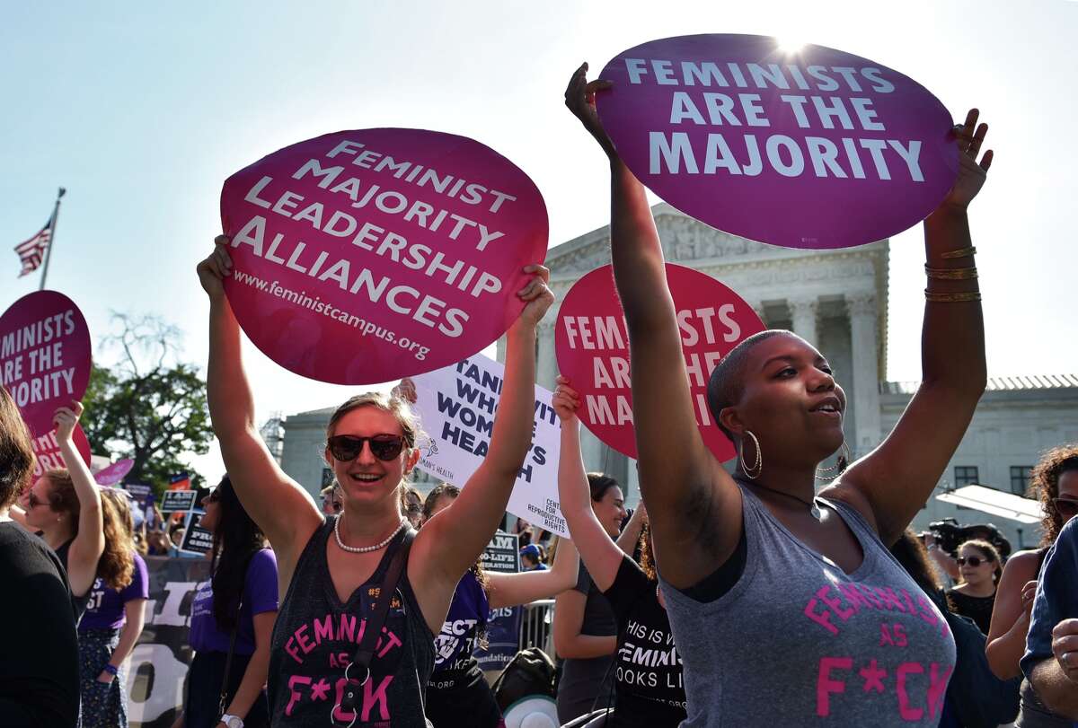 Abortion rights activists hold placards outside of the US Supreme Court ahead of an expected ruling on abortion clinic restrictions on June 27, 2016 in Washington, DC. 