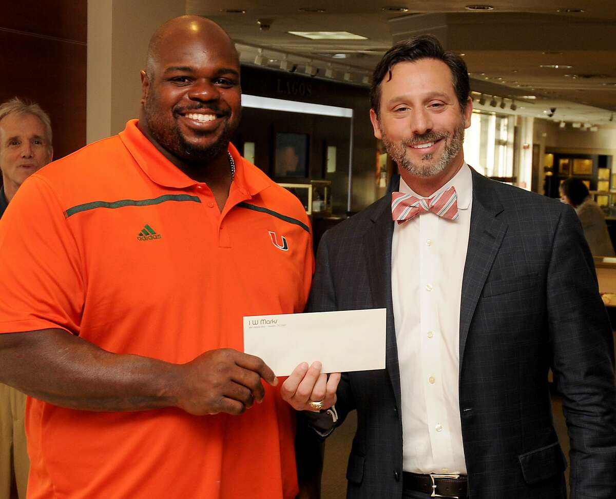 Brad Marks presents the check to Vince Wilfork