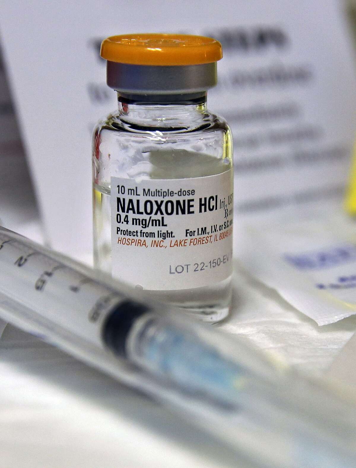 FILE- In this Wednesday, Feb. 19, 2014, file photograph, a small bottle of the opiate overdose treatment drug, naloxone, also known by its brand name Narcan, is displayed at the South Jersey AIDS Alliance in Atlantic City, N.J. It is becoming easier for friends and family of heroin users or patients abusing strong prescription painkillers to get access to naloxone, a powerful, life-saving antidote, as state lawmakers loosen restrictions on the medicine to fight a growing epidemic. (AP Photo/Mel Evans, File)