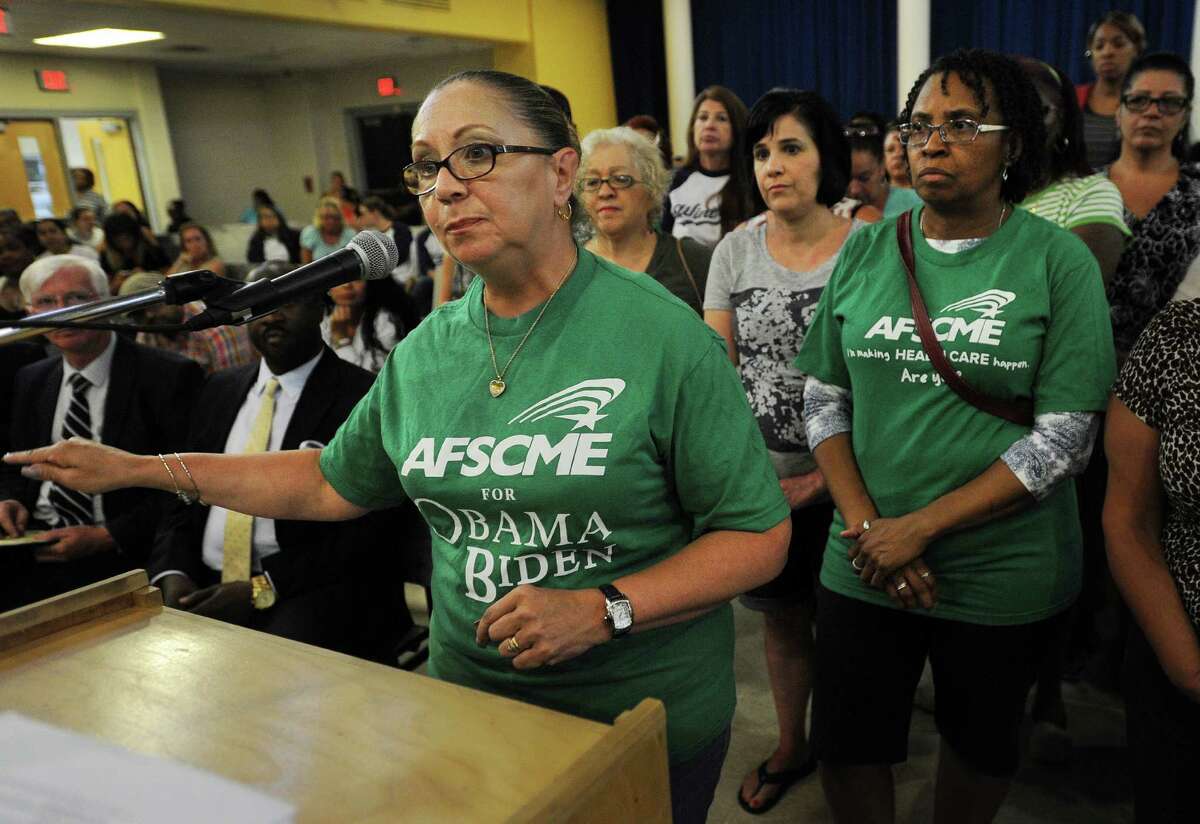Backed by her members, Anna Montalvo, president of AFSCME Local 1522, speaks against the proposed layoffs of kindergarten paraprofessionals at the Bridgeport Board of Education meeting at Geraldine Johnson School in Bridgeport, Conn. on Monday, June 27, 2016.