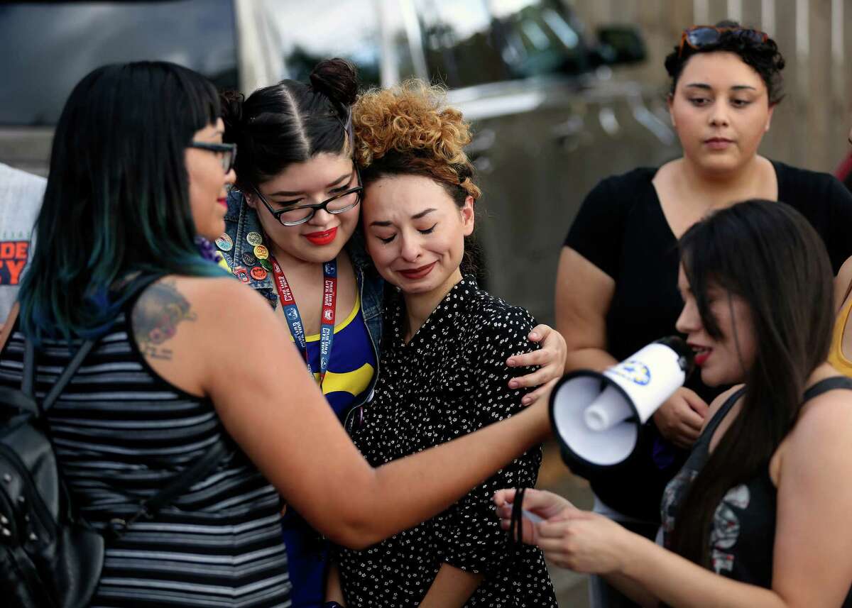Victoria Valdez, second form left, hugs Juanita Renee Rivas, third from left, of the Texas Freedom Network, during a news conference and rally Monday, June 27, 2016 at the Whole Woman's Health of McAllen clinic in McAllen. Valdez and Rivas had gathered with other members of the community to celebrate the Supreme Court's 5-3 ruling that struck down a pair of strict Texas abortion regulations, sparing nearly a dozen clinics in the state from imminent closure.