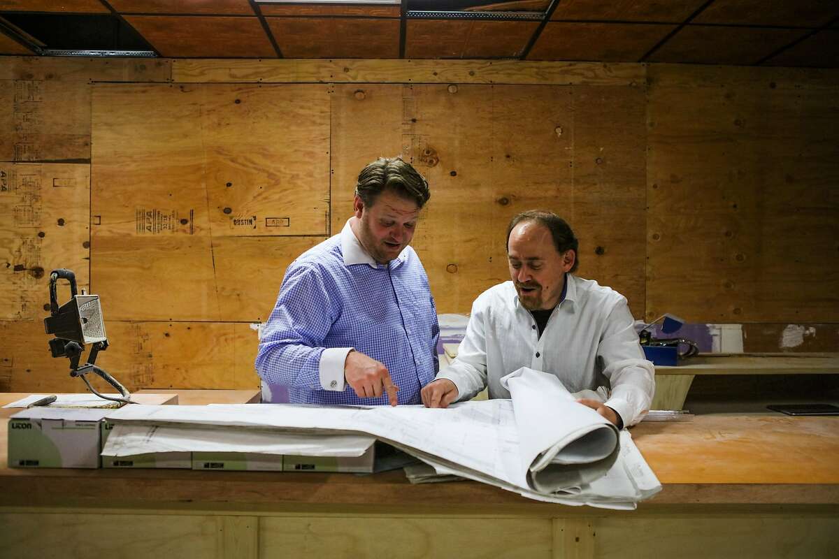 (l-r) Nick Olivero and David Gluck look at architectural drawings while discussing the construction to the theater space, The Speakeasy, in San Francisco, California, on Thursday, June 16, 2016.